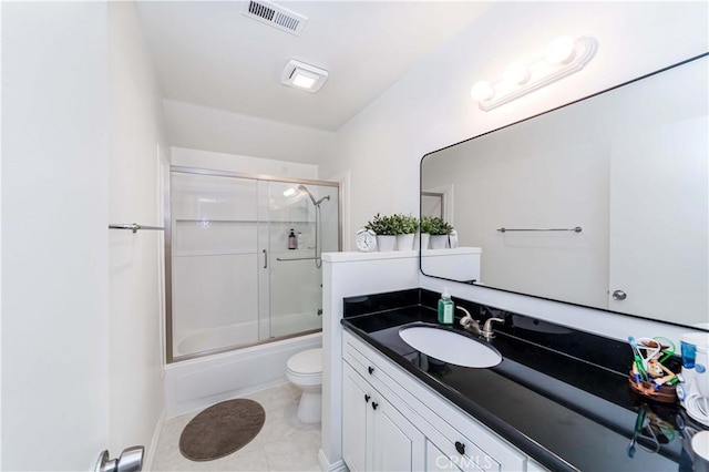 full bathroom featuring tile patterned flooring, enclosed tub / shower combo, vanity, and toilet