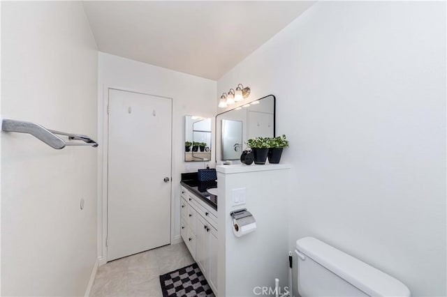 bathroom with tile patterned floors, toilet, and vanity