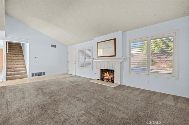 unfurnished living room featuring a fireplace, light colored carpet, and vaulted ceiling