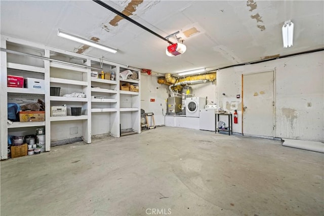 garage with washing machine and dryer and a garage door opener