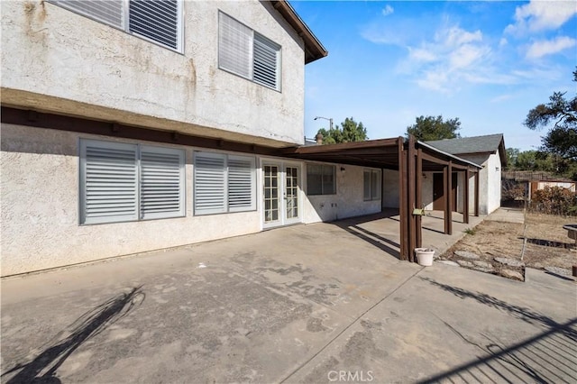 back of property featuring french doors and a patio