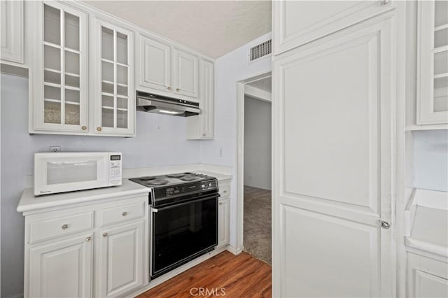 kitchen featuring electric stove, dark hardwood / wood-style flooring, and white cabinetry