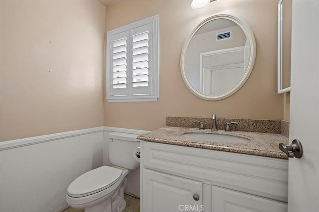 bathroom with toilet and vanity