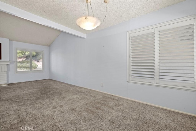 unfurnished room with carpet floors, lofted ceiling with beams, and a textured ceiling