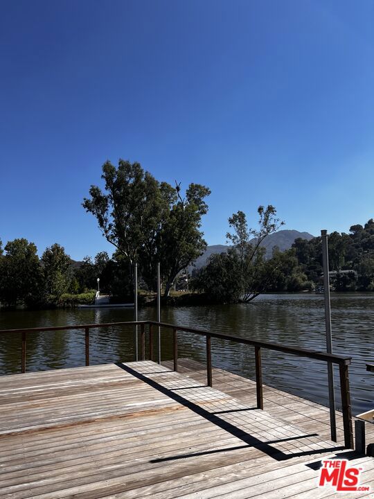 view of dock featuring a water and mountain view