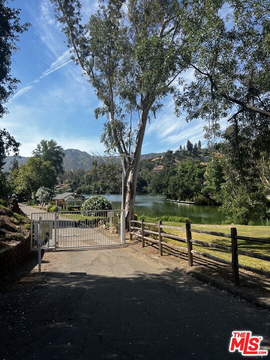 view of yard featuring a water and mountain view