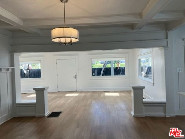 entrance foyer with plenty of natural light, crown molding, hardwood / wood-style flooring, and beamed ceiling