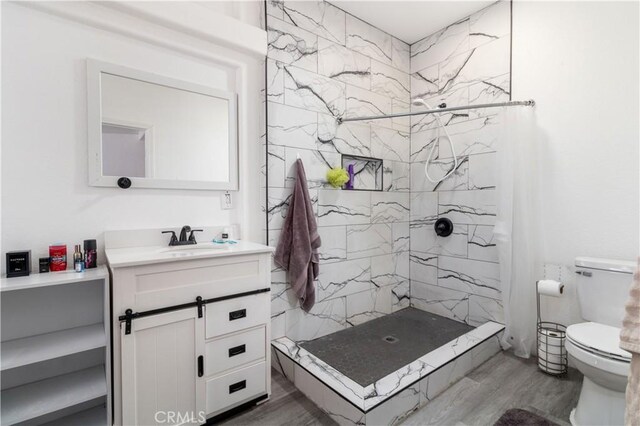 51490 Forest Boundry Rd, Anza, CA 92539 - bathroom with toilet, vanity, hardwood / wood-style floors, and a tile shower