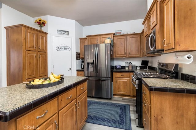 51490 Forest Boundry Rd, Anza, CA 92539 - kitchen featuring light hardwood / wood-style floors, a center island, and stainless steel appliances