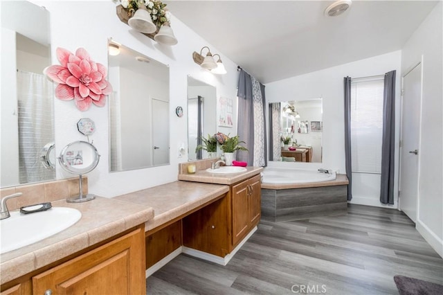 51490 Forest Boundry Rd, Anza, CA 92539 - bathroom with tiled bath, wood-type flooring, and vanity