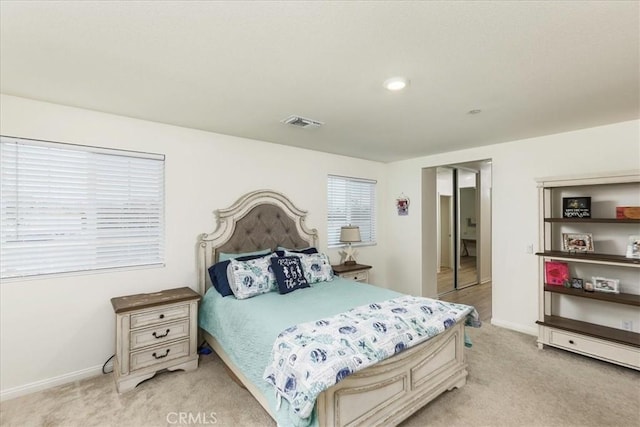 bedroom with visible vents, baseboards, and light colored carpet