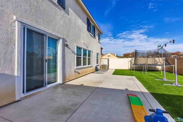 view of patio / terrace with a trampoline and a fenced backyard