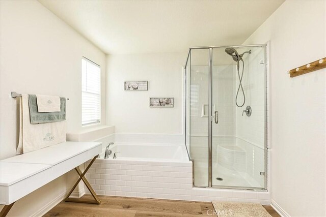 bathroom featuring wood-type flooring and independent shower and bath