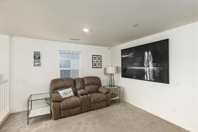 carpeted living room with baseboards and visible vents