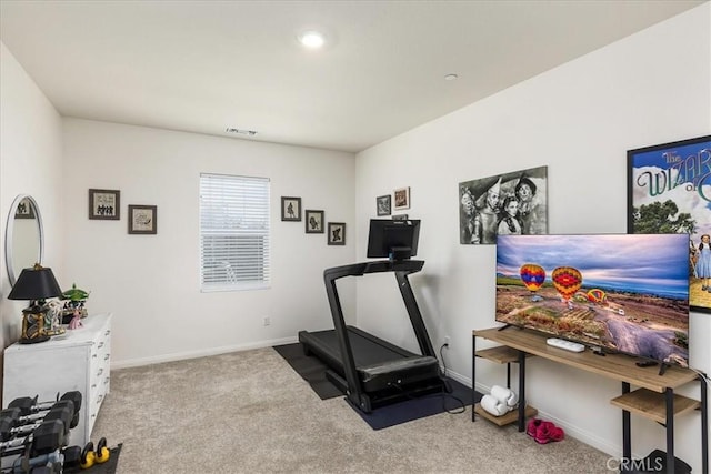 workout room with carpet flooring, baseboards, and visible vents