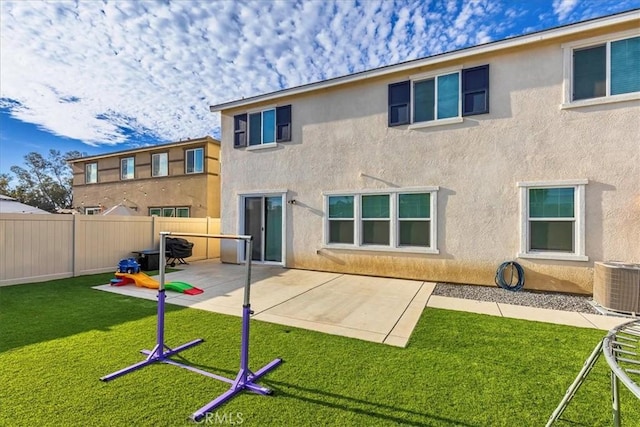 rear view of house featuring central AC, a yard, and a patio