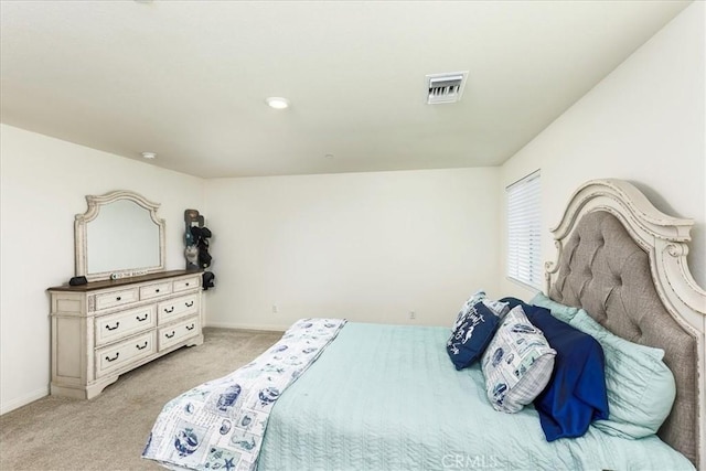 bedroom featuring baseboards, light carpet, and visible vents