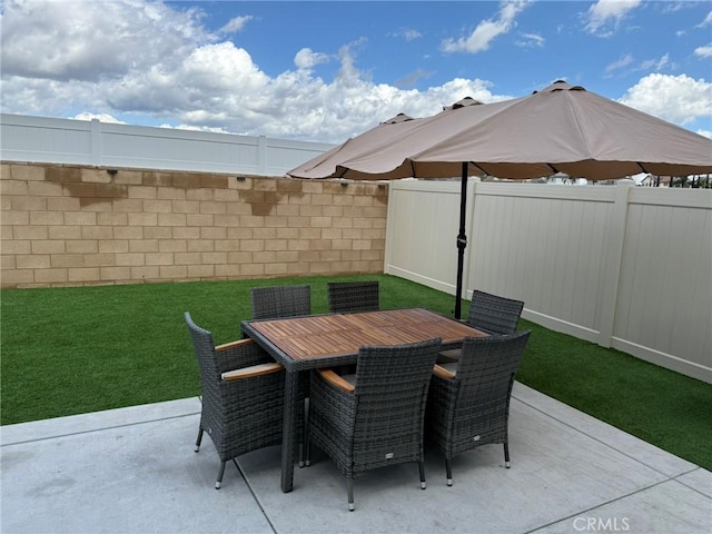 view of patio featuring outdoor dining space and a fenced backyard