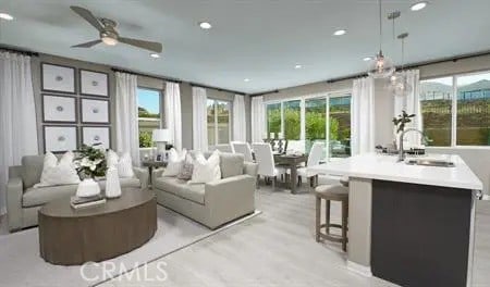 sunroom / solarium with ceiling fan and sink