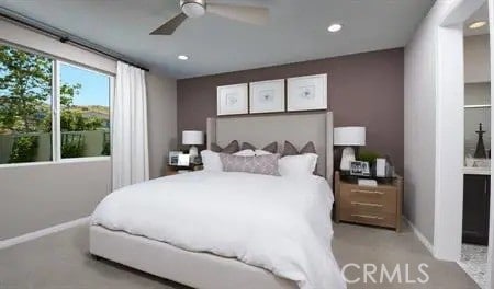 bedroom featuring ceiling fan and connected bathroom