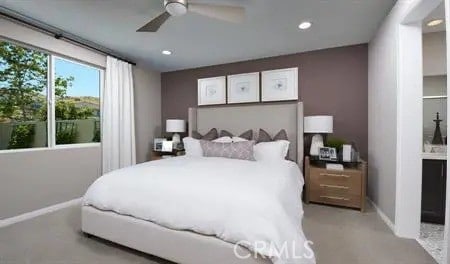 bedroom featuring ceiling fan and ensuite bathroom