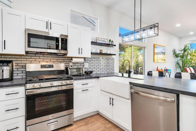 kitchen featuring sink, white cabinets, and appliances with stainless steel finishes