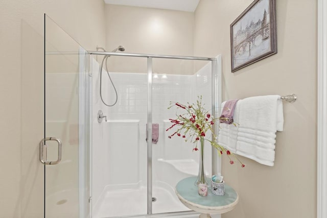 bathroom with a shower with door