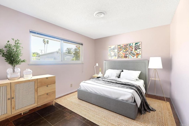 tiled bedroom with a textured ceiling