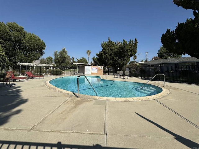 view of swimming pool with a patio area