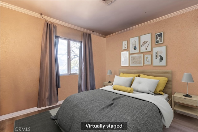 bedroom with crown molding and hardwood / wood-style flooring