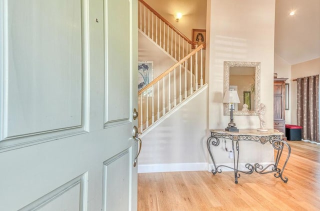 foyer entrance featuring light wood-type flooring and lofted ceiling