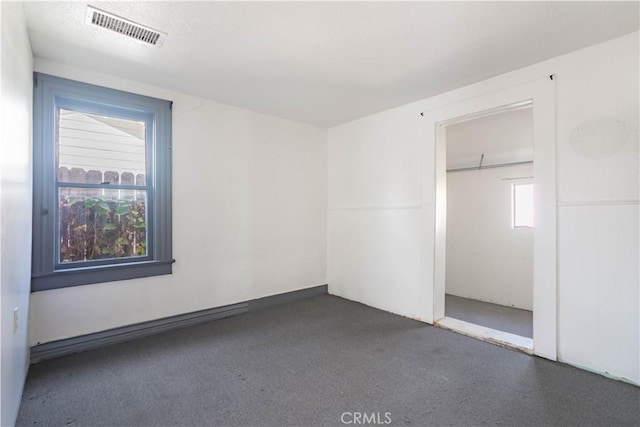 unfurnished bedroom featuring a closet and multiple windows