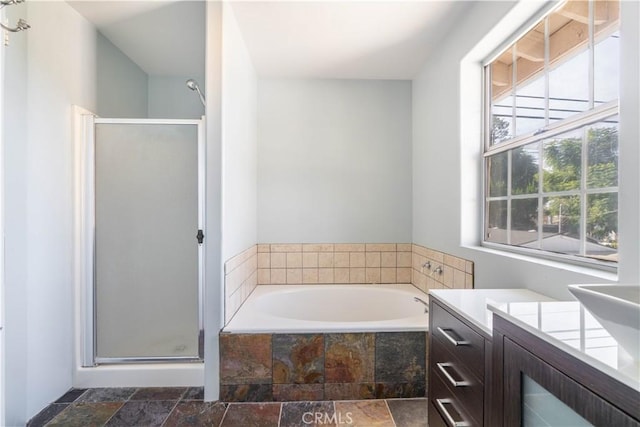 bathroom with vanity and shower with separate bathtub