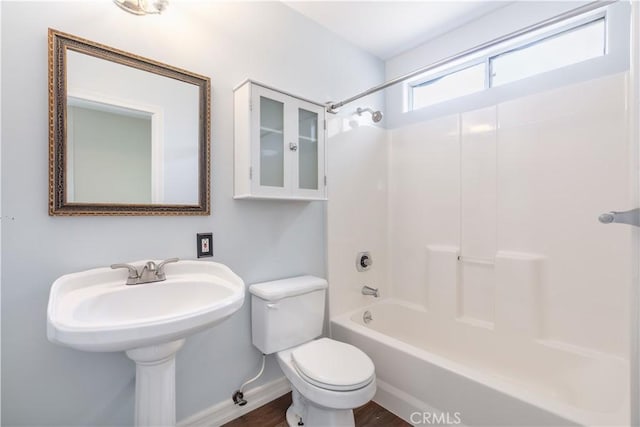 full bathroom with toilet, sink, and shower / washtub combination