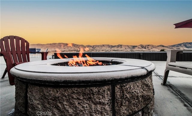 view of patio featuring a mountain view and an outdoor fire pit