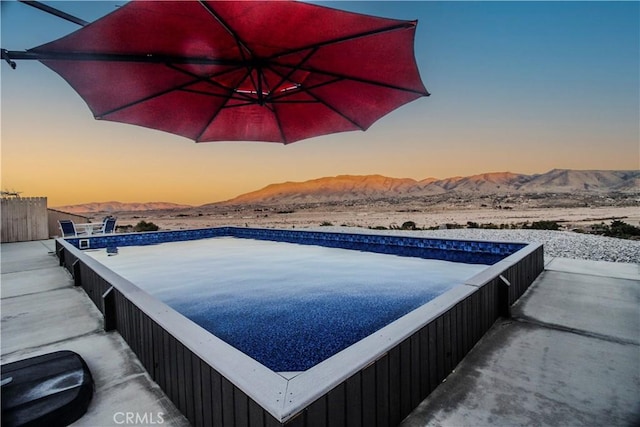 view of swimming pool with a mountain view