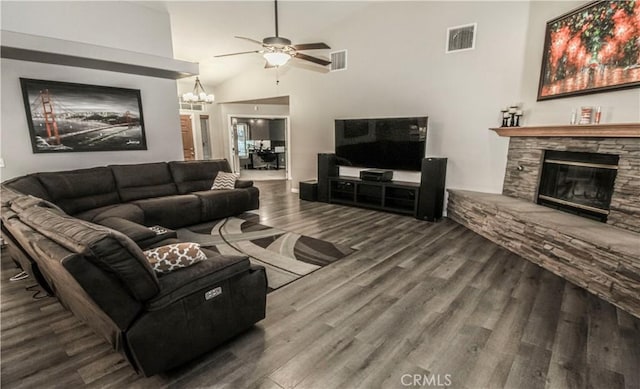 living area with a ceiling fan, wood finished floors, a fireplace, and visible vents