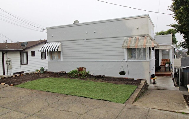 view of home's exterior with a yard