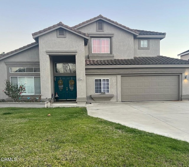 view of front property featuring a front lawn and a garage