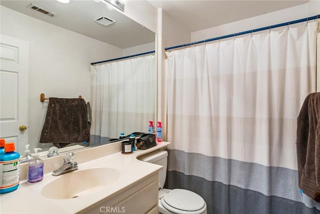 bathroom with toilet and vanity