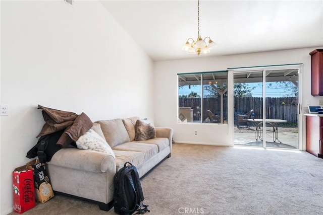 living room with carpet floors, a chandelier, and lofted ceiling