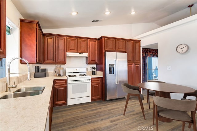 kitchen featuring lofted ceiling, stainless steel refrigerator with ice dispenser, sink, white range with gas stovetop, and dark hardwood / wood-style flooring