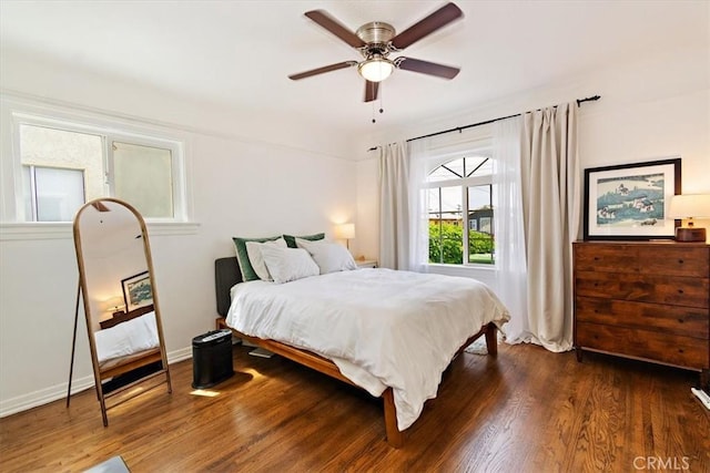 bedroom with ceiling fan and dark hardwood / wood-style floors