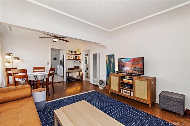 living room with ceiling fan and dark hardwood / wood-style floors