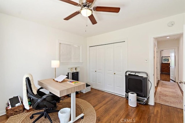 office with ceiling fan and dark wood-type flooring