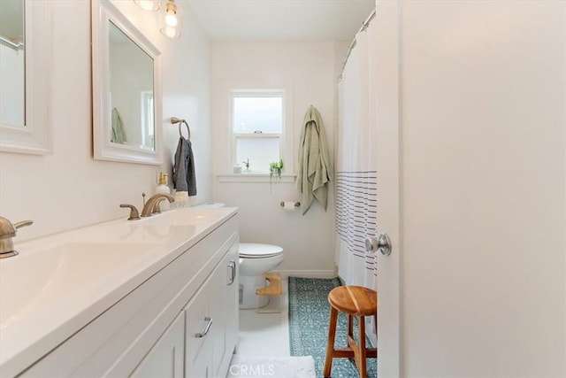 bathroom featuring toilet and vanity