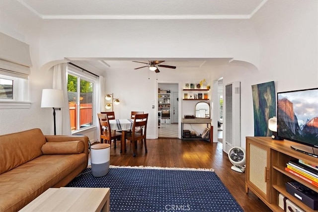 living room featuring ceiling fan and dark hardwood / wood-style flooring