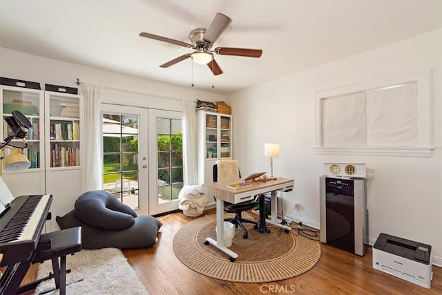 home office with ceiling fan, wood-type flooring, and french doors