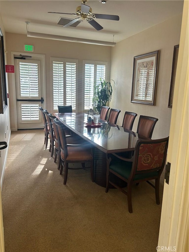 dining room featuring light carpet and ceiling fan