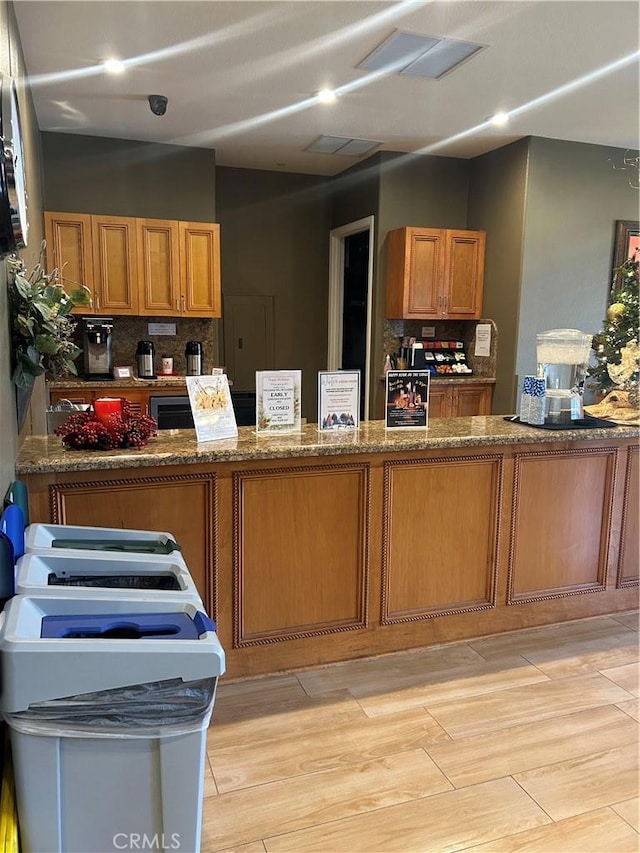 kitchen featuring dark stone countertops and backsplash